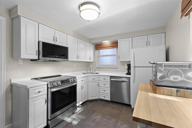 752 Washington, Ross Twp, PA 15229 - kitchen with appliances with stainless steel finishes, white cabinetry, and a sink