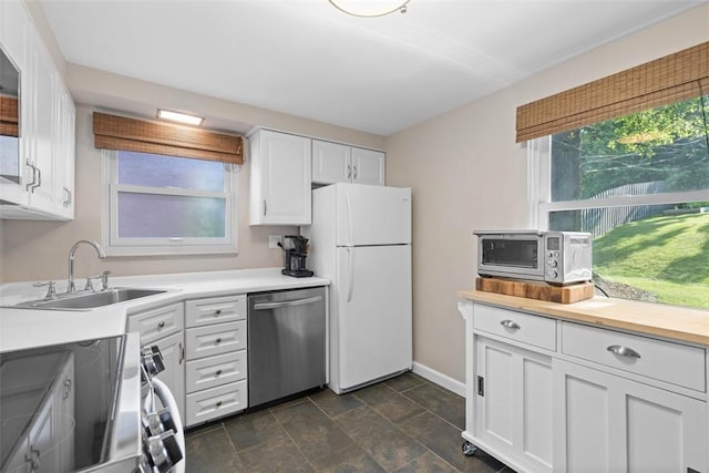 752 Washington, Ross Twp, PA 15229 - kitchen featuring appliances with stainless steel finishes, a sink, white cabinets, baseboards, and light countertops