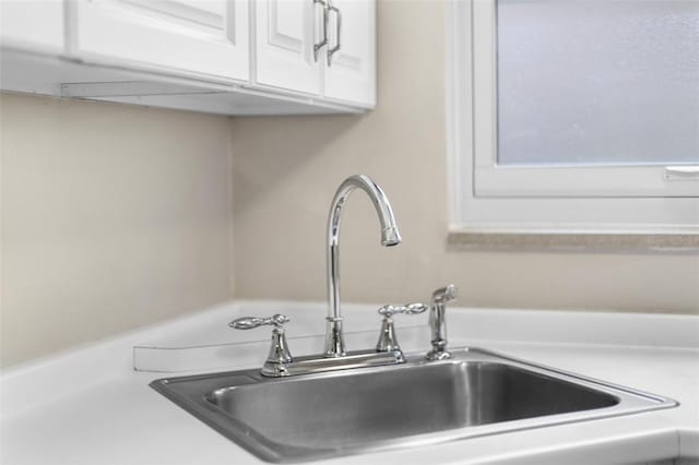 752 Washington, Ross Twp, PA 15229 - detailed view of a sink, white cabinets, and light countertops