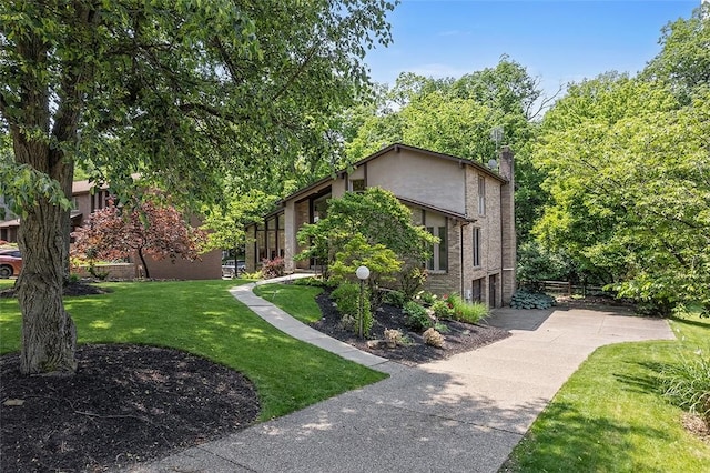 1648 Little Meadow Rd, Upper St Clair, PA 15241 - view of side of home with an attached garage, a chimney, a yard, driveway, and stucco siding
