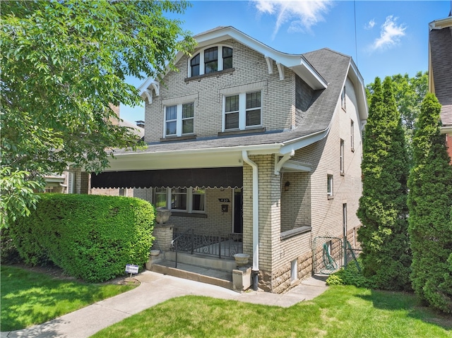 1150 Morningside Ave, Morningside, PA 15206 - view of front of house with brick siding, a front lawn, and a shingled roof
