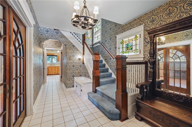 1150 Morningside Ave, Morningside, PA 15206 - stairway featuring wallpapered walls, tile patterned floors, a chandelier, french doors, and baseboards
