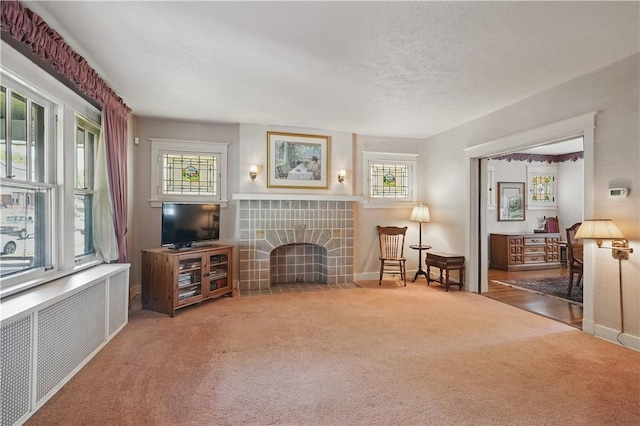1150 Morningside Ave, Morningside, PA 15206 - living room with carpet flooring, a tile fireplace, and baseboards