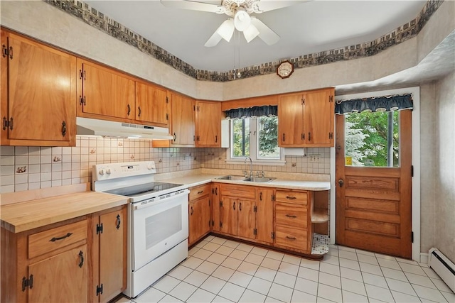 1150 Morningside Ave, Morningside, PA 15206 - kitchen with white electric range, a sink, under cabinet range hood, a baseboard heating unit, and plenty of natural light
