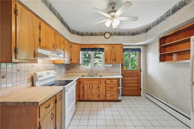 1150 Morningside Ave, Morningside, PA 15206 - kitchen featuring electric stove, a baseboard radiator, under cabinet range hood, a sink, and decorative backsplash