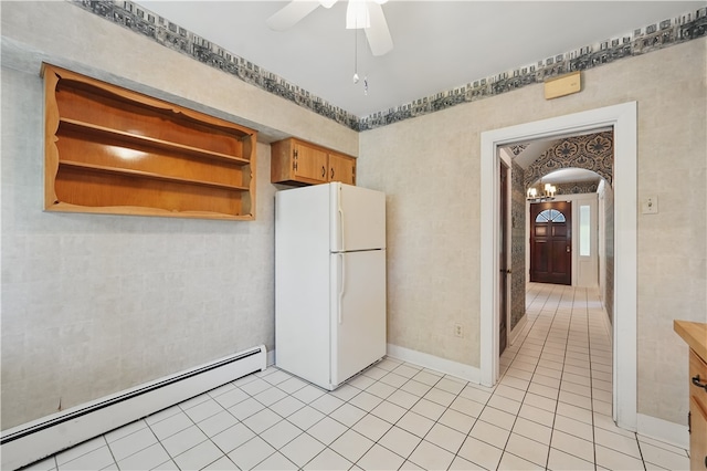 1150 Morningside Ave, Morningside, PA 15206 - kitchen with freestanding refrigerator, baseboard heating, arched walkways, light tile patterned floors, and a ceiling fan