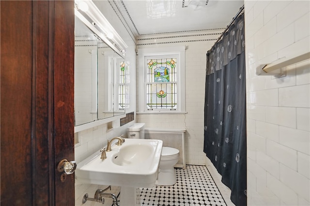 1150 Morningside Ave, Morningside, PA 15206 - bathroom with toilet, tile walls, a shower with shower curtain, radiator heating unit, and a sink