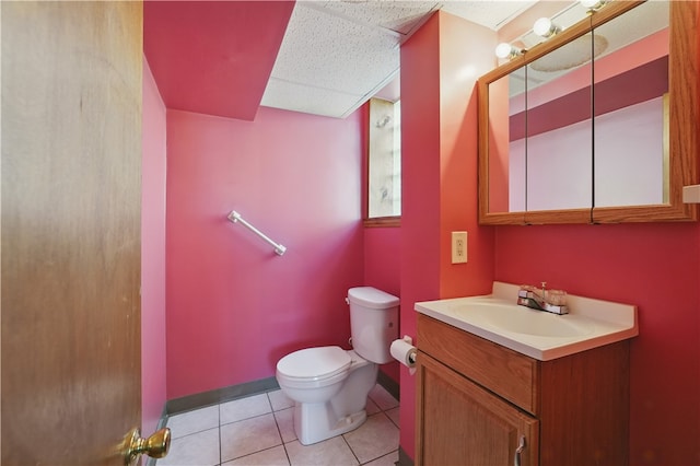 1150 Morningside Ave, Morningside, PA 15206 - bathroom featuring toilet, vanity, tile patterned floors, a drop ceiling, and baseboards