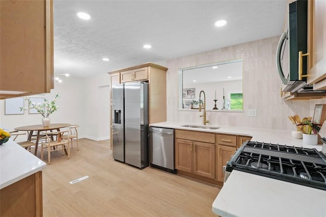 507 Edgehill Dr, Richland, PA 15044 - kitchen featuring appliances with stainless steel finishes, a sink, light countertops, light wood-style flooring, and recessed lighting