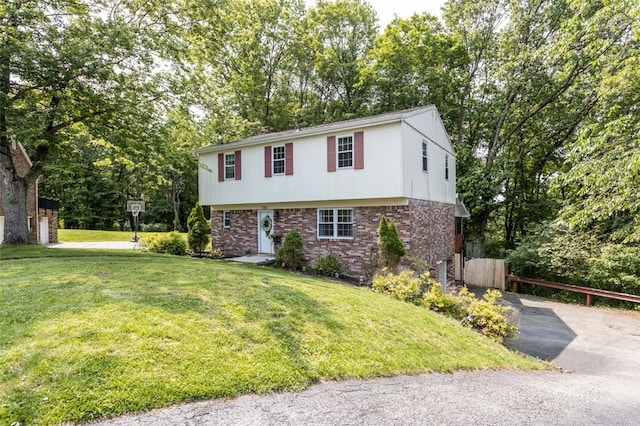 765 Brookshire Dr, Mccandless, PA 15237 - colonial-style house with brick siding, asphalt driveway, and view of scattered trees