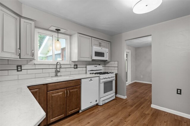 765 Brookshire Dr, Mccandless, PA 15237 - kitchen with white appliances, a sink, backsplash, light countertops, and baseboards