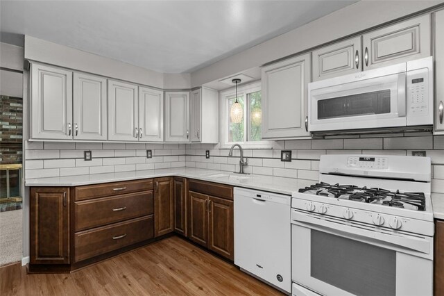 765 Brookshire Dr, Mccandless, PA 15237 - kitchen with white appliances, a sink, light countertops, and light wood-type flooring