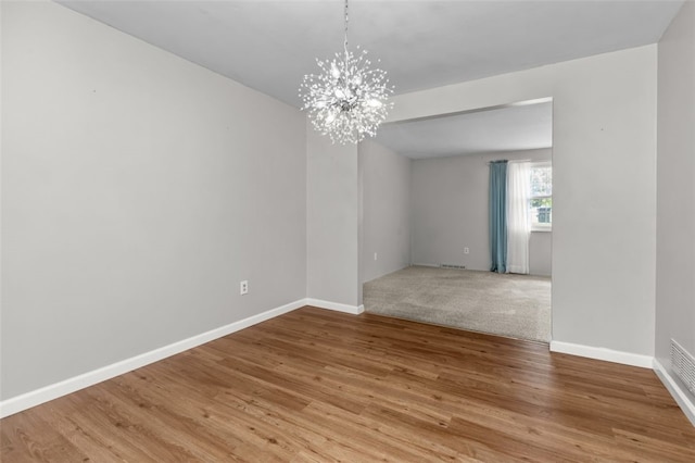 765 Brookshire Dr, Mccandless, PA 15237 - empty room with a chandelier, wood finished floors, and baseboards