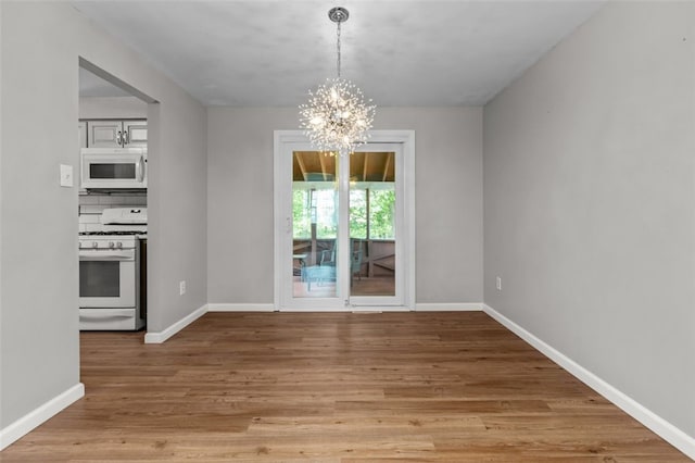 765 Brookshire Dr, Mccandless, PA 15237 - unfurnished dining area featuring a chandelier, light wood-style floors, and baseboards