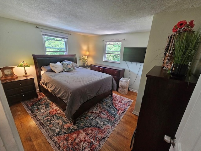 1099 Vine St, Coraopolis, PA 15108 - bedroom with a textured ceiling, multiple windows, and wood finished floors