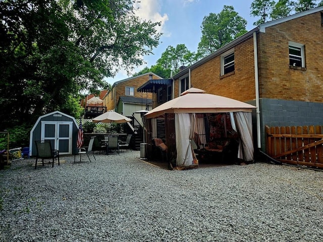 1099 Vine St, Coraopolis, PA 15108 - rear view of house featuring a gazebo, brick siding, and a patio area