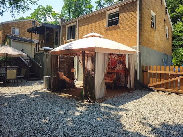 1099 Vine St, Coraopolis, PA 15108 - back of house with a gazebo, brick siding, and a patio area