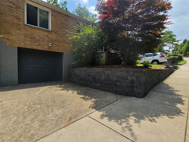 1099 Vine St, Coraopolis, PA 15108 - view of side of home with an attached garage and concrete driveway
