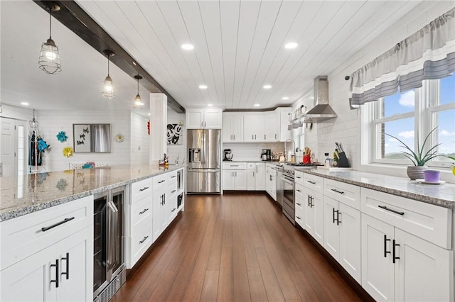 155 Pride Dr, Rostraver, PA 15012 - kitchen featuring appliances with stainless steel finishes, wall chimney exhaust hood, wine cooler, recessed lighting, and white cabinetry