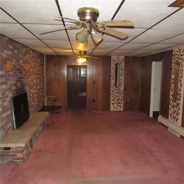313 Dalton Run Rd, Conemaugh Twp Som, PA 15905 - finished basement with carpet flooring, ceiling fan, a paneled ceiling, wood walls, and a wood stove