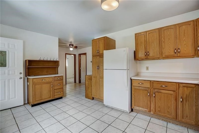 952 Seybertown Rd, Perry Twp, PA 16041 - kitchen with freestanding refrigerator, brown cabinets, light countertops, a ceiling fan, and light tile patterned floors