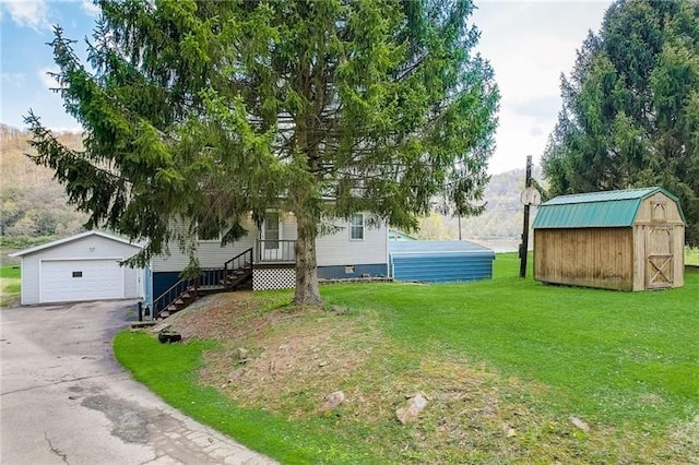 952 Seybertown Rd, Perry Twp, PA 16041 - view of green lawn with an outbuilding and a detached garage