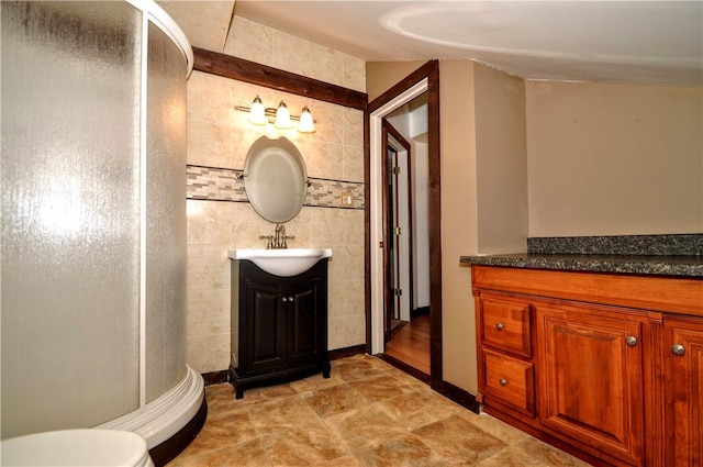 232 Center Ave, Elizabeth Twp/Boro, PA 15037 - bathroom featuring vanity, a stall shower, toilet, and tile walls