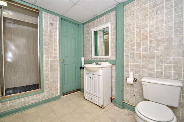 232 Center Ave, Elizabeth Twp/Boro, PA 15037 - bathroom with vanity, toilet, a shower stall, tile walls, and a paneled ceiling