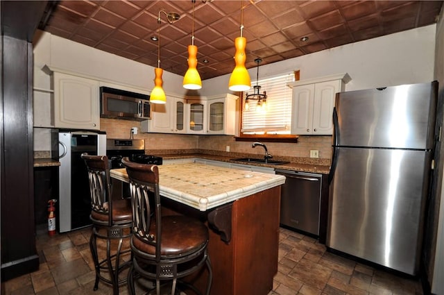 232 Center Ave, Elizabeth Twp/Boro, PA 15037 - kitchen with appliances with stainless steel finishes, a sink, dark stone finish floors, and decorative backsplash