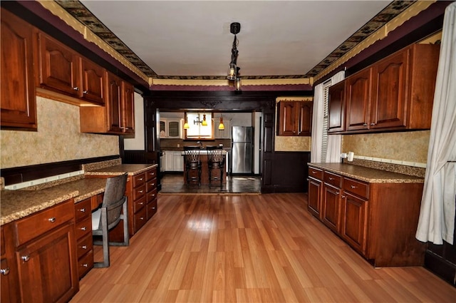232 Center Ave, Elizabeth Twp/Boro, PA 15037 - kitchen with freestanding refrigerator, light wood finished floors, decorative light fixtures, and dark countertops
