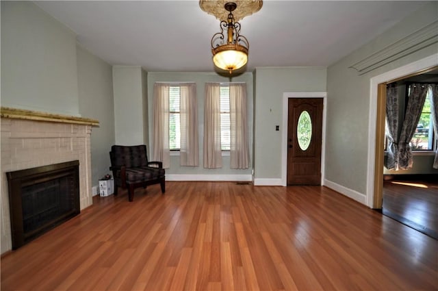 232 Center Ave, Elizabeth Twp/Boro, PA 15037 - foyer entrance featuring plenty of natural light, wood finished floors, and a brick fireplace