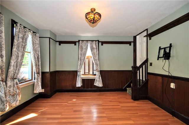 232 Center Ave, Elizabeth Twp/Boro, PA 15037 - empty room featuring wainscoting, wood finished floors, wood walls, and stairway