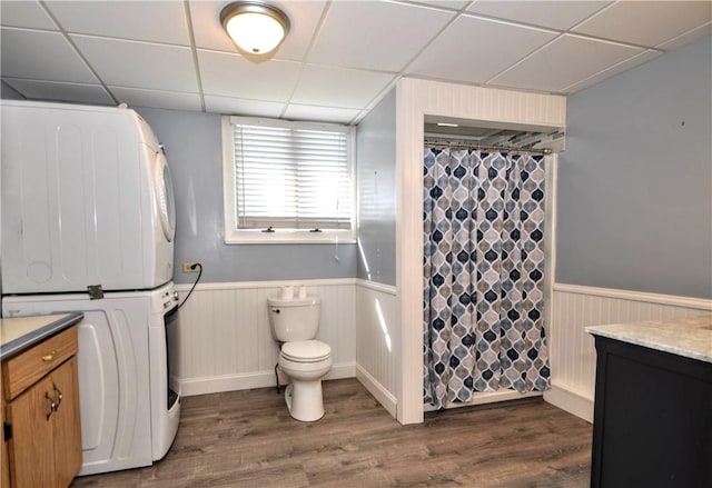 232 Center Ave, Elizabeth Twp/Boro, PA 15037 - bathroom featuring stacked washer and clothes dryer, a paneled ceiling, a wainscoted wall, vanity, and wood finished floors