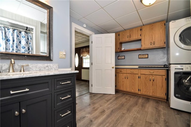 232 Center Ave, Elizabeth Twp/Boro, PA 15037 - washroom with stacked washing machine and dryer and dark wood finished floors