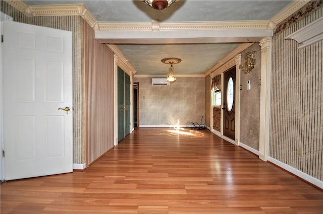 232 Center Ave, Elizabeth Twp/Boro, PA 15037 - spare room featuring ornamental molding, wood finished floors, baseboards, wallpapered walls, and an AC wall unit
