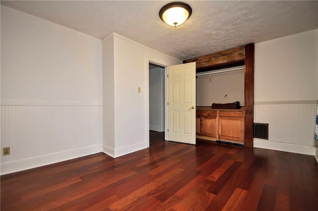 232 Center Ave, Elizabeth Twp/Boro, PA 15037 - unfurnished bedroom featuring dark wood finished floors, a wainscoted wall, and baseboards