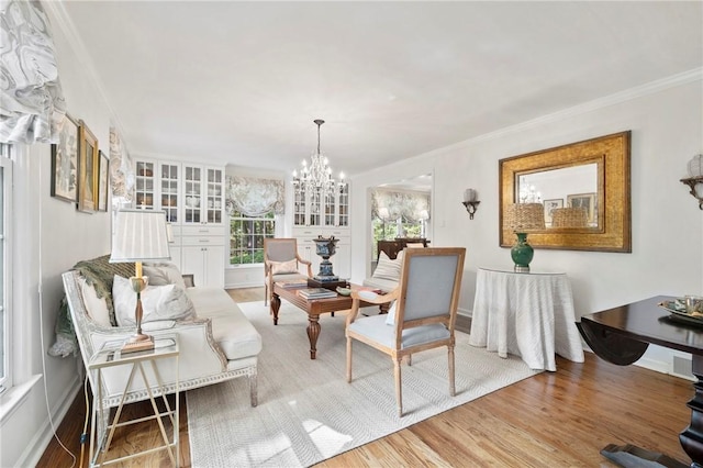 306 Wildberry Rd, Fox Chapel, PA 15238 - living room featuring a chandelier, wood finished floors, crown molding, and baseboards