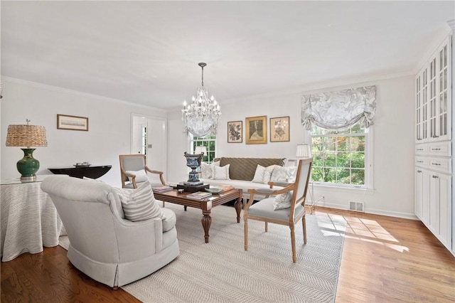 306 Wildberry Rd, Fox Chapel, PA 15238 - living area with a chandelier, light wood finished floors, ornamental molding, and baseboards