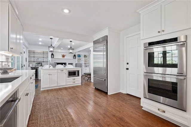 306 Wildberry Rd, Fox Chapel, PA 15238 - kitchen with built in appliances, open floor plan, recessed lighting, white cabinetry, and beamed ceiling