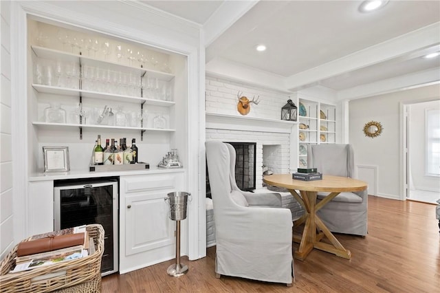 306 Wildberry Rd, Fox Chapel, PA 15238 - indoor dry bar featuring beverage cooler, wood finished floors, ornamental molding, a fireplace, and recessed lighting