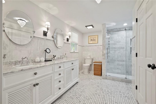 306 Wildberry Rd, Fox Chapel, PA 15238 - full bathroom with tile walls, toilet, double vanity, a shower stall, and a wainscoted wall