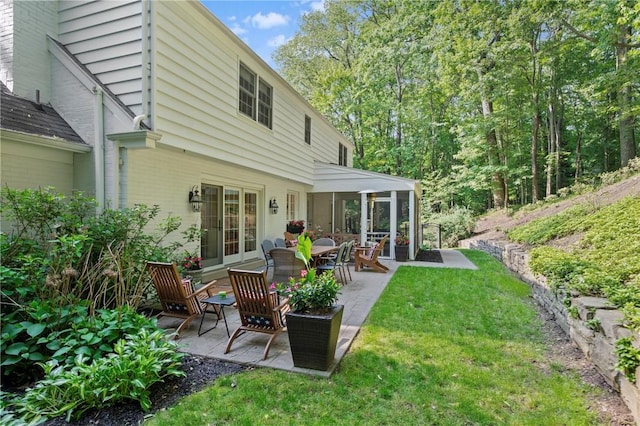 306 Wildberry Rd, Fox Chapel, PA 15238 - rear view of property featuring a patio, brick siding, a yard, and a sunroom