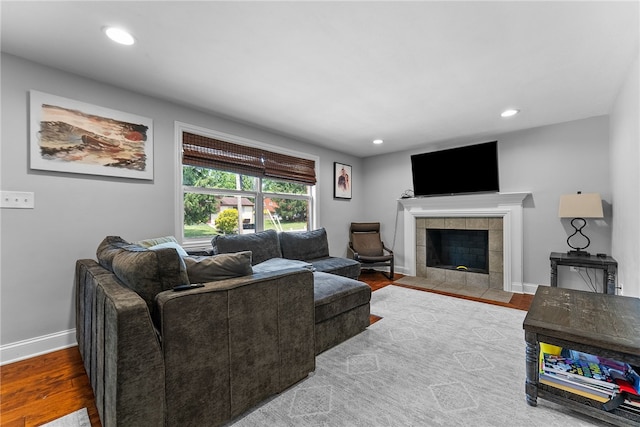1368 Berryman Ave, South Park, PA 15129 - living room featuring baseboards, wood finished floors, a tiled fireplace, and recessed lighting