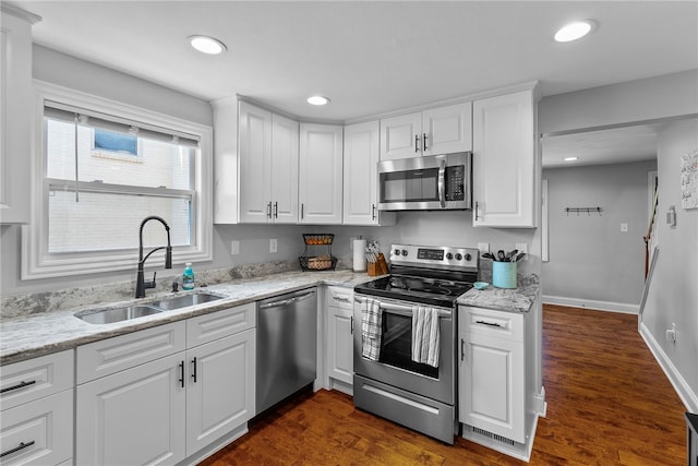 1368 Berryman Ave, South Park, PA 15129 - kitchen with appliances with stainless steel finishes, a sink, white cabinets, dark wood-type flooring, and recessed lighting