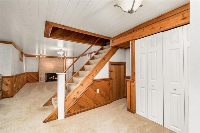 109 Parkview Rd, Ross Twp, PA 15237 - finished below grade area featuring carpet floors, a brick fireplace, wainscoting, stairway, and wood walls
