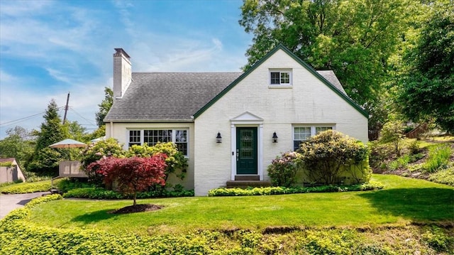 109 Parkview Rd, Ross Twp, PA 15237 - english style home featuring a chimney, a front yard, roof with shingles, and brick siding