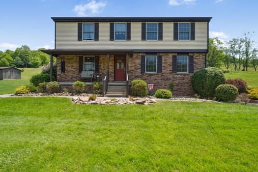 184 Potato Run Rd, Amwell, PA 15301 - view of front of home with covered porch, brick siding, and a front lawn