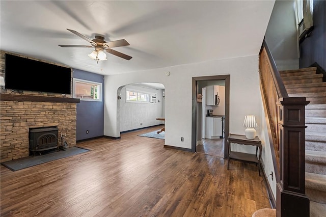 159 Jefferson Ave, Vandergrift Wml, PA 15690 - unfurnished living room featuring a ceiling fan, dark wood-style floors, stairs, arched walkways, and baseboards