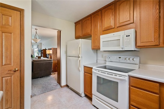 3028 Wachter Ave, Lower Burrell, PA 15068 - kitchen featuring white appliances, light countertops, and brown cabinets