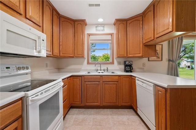 3028 Wachter Ave, Lower Burrell, PA 15068 - kitchen with white appliances, a sink, brown cabinets, light countertops, and recessed lighting